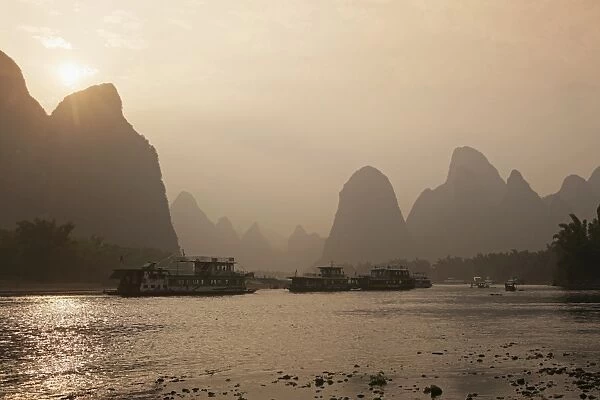 Cruise boats between Guilin and Yangshuo at sunset, Li River, Guilin, Guangxi Province