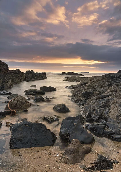 Dawn breaking over Bamburgh beach and the Farne Islands, Northumberland, England