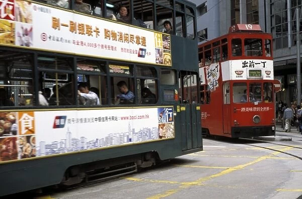 Two double decker trams passing at Sheung Wan, Hong Kong, China, Asia