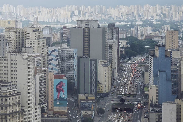Elevated view of downtown skyscrapers, heavy traffic on Avenue Prestes Maia, rainy season sky, Sao Paulo, Brazil, South America