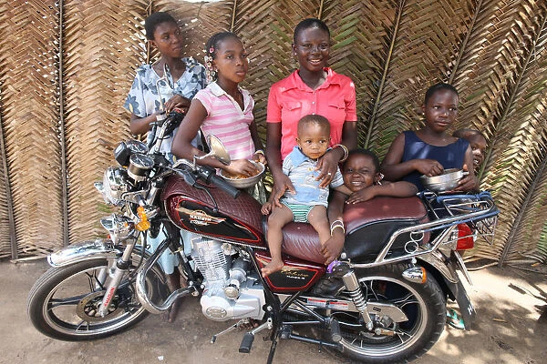 Family around a motocycle, Lome, Togo, West Africa, Africa