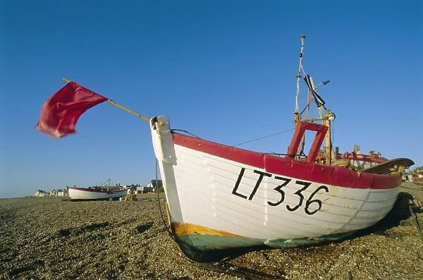 Fishing boat with red flag on the beach, Aldeburgh, Suffolk, England, UK, Europe