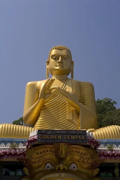 Giant gold seated Buddha statue at entrance to the Cave Temples