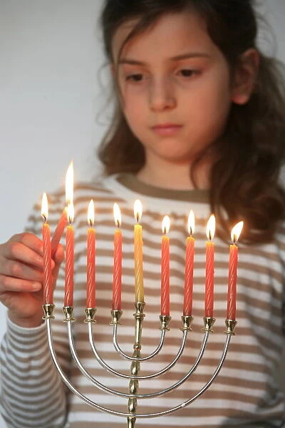 Girl lighting Hannuka candles, Montrouge, France, Europe