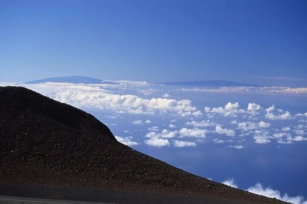 The two great 13000ft volcanic peaks of Mauna Loa on right, and Mauna Kea on the Big Island seen from the top of the Haleakala volcano, Maui, Hawaii, Hawaiian Islands, United States of America, Pacific