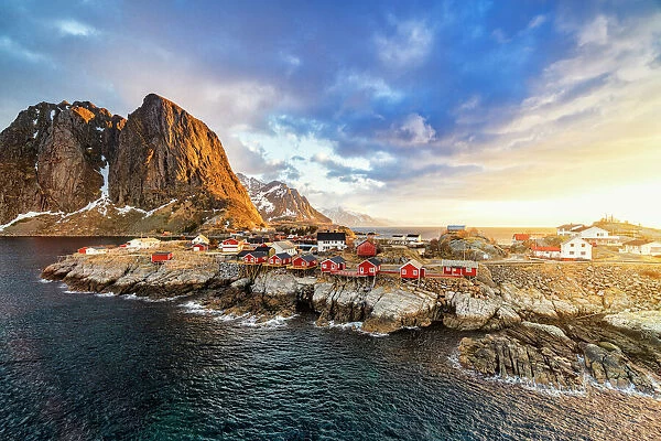 High angle view of majestic mountains and Hamnoy village lit by the warm light of sunrise, Reine, Lofoten Islands, Norway, Europe