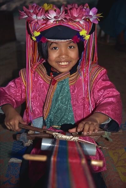 Hill tribe girl weaving on a narrow loom in Chiang Mai