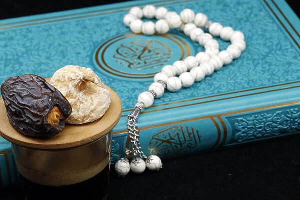 Holy Quran book with prayer beads and date, Ramadan concept, Muslim faith and religion
