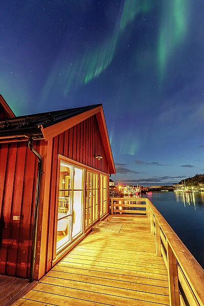 Illuminated red cabin under the Northern Lights, Hamnoy, Reine, Lofoten Islands, Nordland, Norway, Scandinavia, Europe