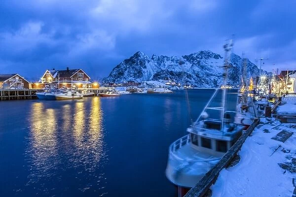 The lights of the harbor of Henningsvaer, the most important in the Lofoten, lit at the blue hour, Lofoten Islands, Arctic, Norway, Scandinavia, Europe
