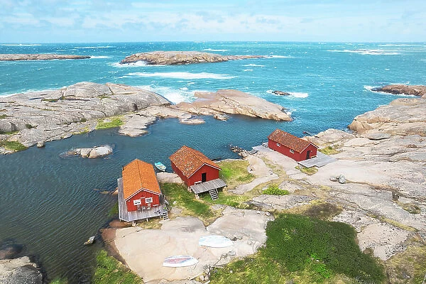 Lonely wooden red cottages on a rocky coast, Bohuslan, Vastra Gotaland, West Sweden, Scandinavia, Europe