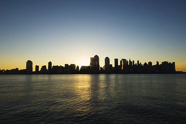 Lower Manhattan skyline at dawn across the Hudson River