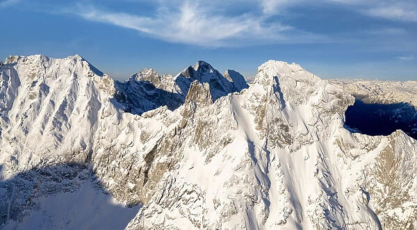 Majestic rock pinnacles of Pioda Di Sciora peak covered with snow, aerial view