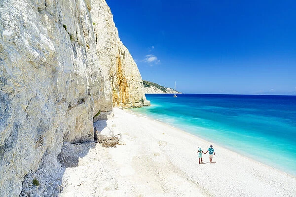 Man and woman holding hands on the idyllic Fteri Beach, overhead view, Kefalonia, Ionian Islands, Greek Islands, Greece, Europe