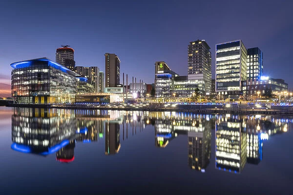 MediaCityUK reflected in North Bay at night, Salford Quays, Salford, Manchester, England, United Kingdom, Europe