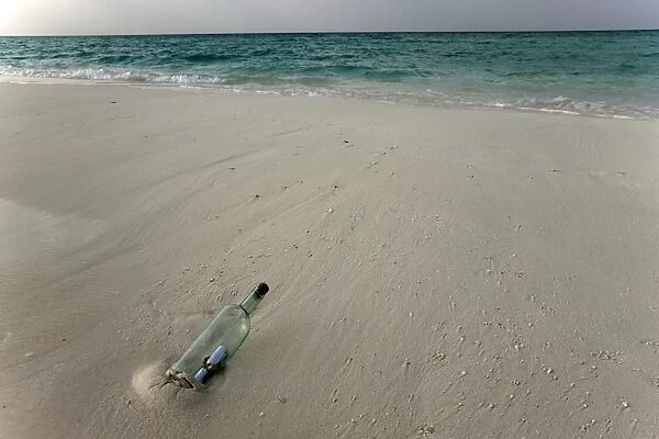Message in a bottle on a tropical beach, Kuramathi Island, Ari Atoll, Maldives