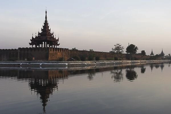 Moat surrrounding walled palace and fort compound at dusk, Mandalay, Myanmar (Burma)