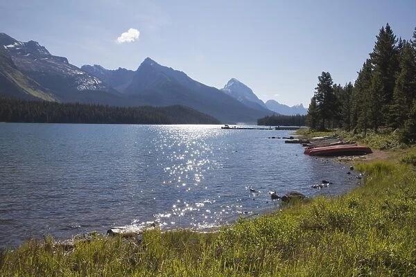Morning light on Maligne Lake with canoes on shoreline, Jasper National Park