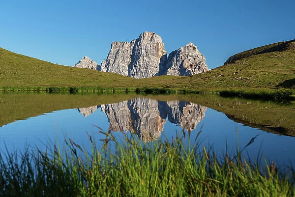 Mount Pelmo reflected in the water of Baste Lake, Giau Pass, Dolomites of Belluno, Veneto, Italy, Europe