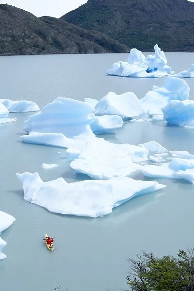Person kayaking between floating icebergs, Lago Gray (Lake Gray), Torres del Paine National Park