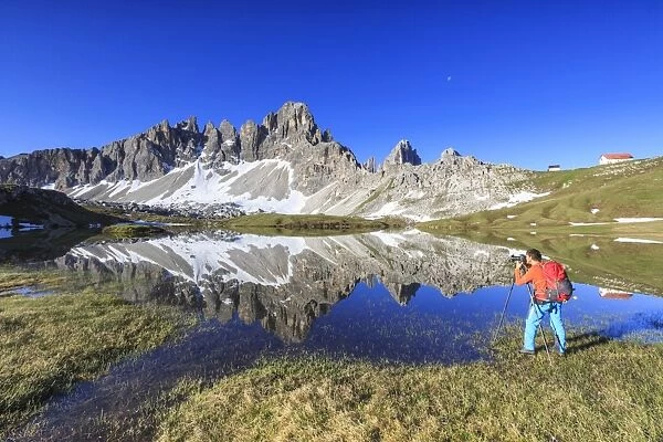 Photographer captures the Mount Paterno reflected in the lake, Sesto, Dolomites