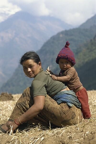 Portrait of a mother and son in a field in Nepal