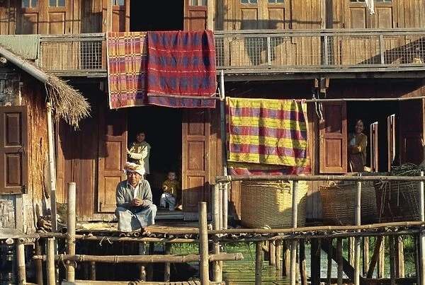 Portrait of a Shah family and a detail of their house on stilts, Inle Lake