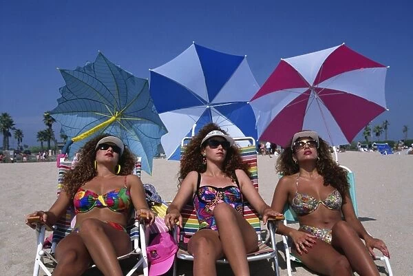 Portrait of three women wearing sunglasses and swimwear