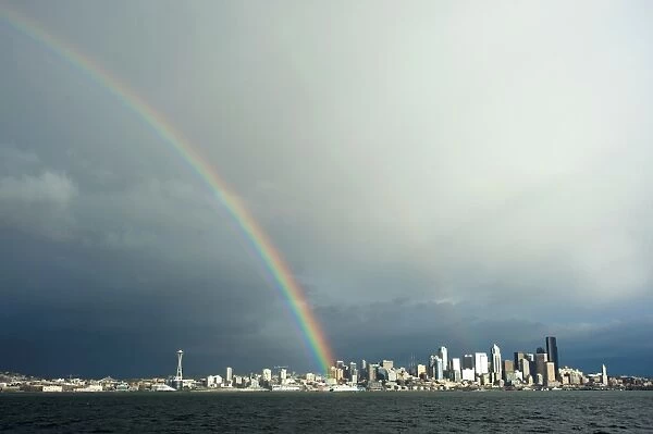 A rainbow lands on a Washington State Ferry in the Puget Sound with the Seattle skyline in the background, Seattle, Washington, United States of America, North America