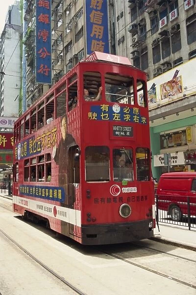 A red double decker tram in a street in Hong Kong, China, Asia