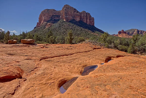 Reflections of Courthouse Butte in the Slick Rock Bowls along the Llama Trail in Sedona