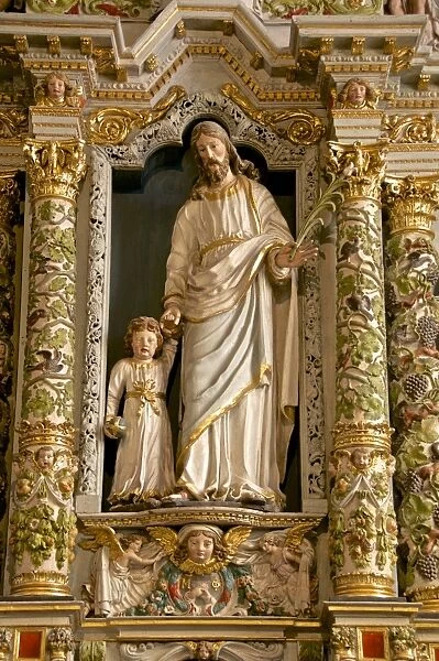 Retable in the Rosary detail dating from the 17th century showing St. Joseph and child, Guimiliau parish church enclosure, Guimiliau, Finistere, Brittany, France, Europe