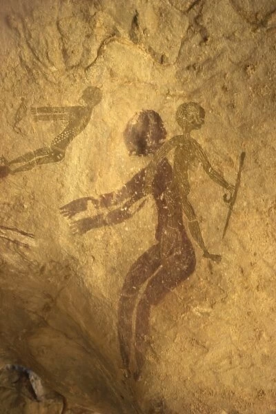 Rock paintings of decorated woman and children on cave, Tassili n Ajjer