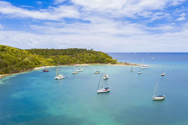Sailboats and catamarans moored in a tropical bay, aerial view by drone, Caribbean Sea