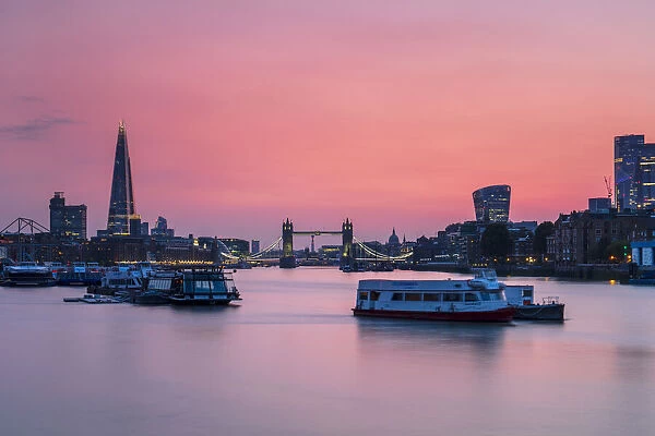 The Shard, Tower Bridge and City of London skyline with river boats on the River Thames at sunset, London, England, United Kingdom, Europe