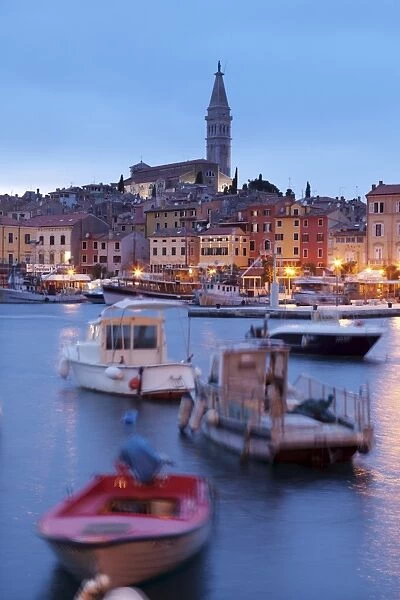 Ships and boats in the harbour and the old town with cathedral of St. Euphemia at dusk, Rovinj, Istria, Croatia, Europe