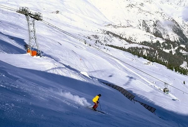 Skier on slopes above village of Solden in Tirol Alps, Tirol, Austria, Europe
