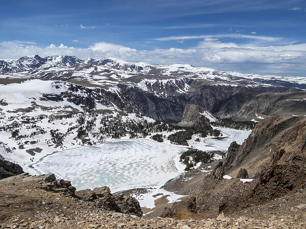 Snow-capped mountains and a frozen lake near Beartooth Pass, Wyoming