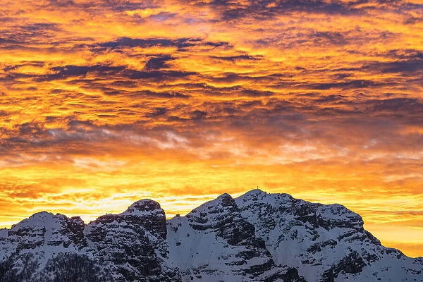 Snowcapped Mount Resegone under the colorful sky at sunrise, Lake Como, Lecco province