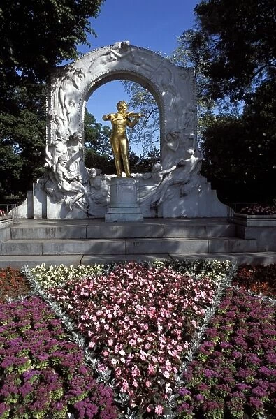 Statue of the composer Johann Strauss on the Strauss Memorial, and flowerbed in Johann Strauss State Park (Stadtpark), Vienna