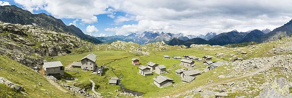 Stone huts and Rifugio Cristina surrounded by Rhaetian Alps, Alpe Prabello, Valmalenco