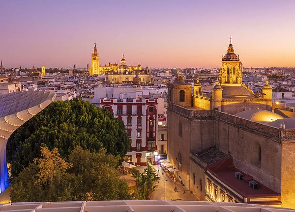 Sunset Seville skyline of Cathedral and city rooftops from the Metropol Parasol, Seville