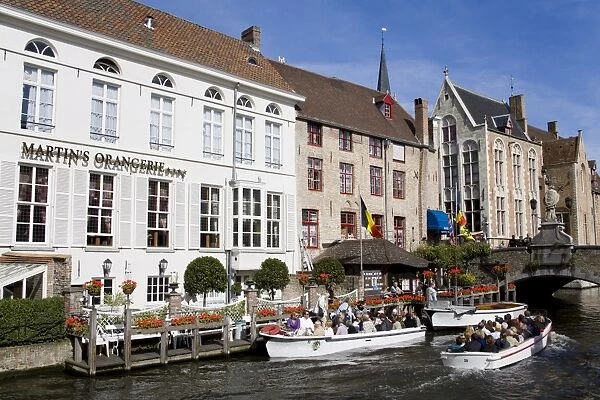 Tour boat on the canal in Bruges, West Flanders, Belgium, Europe