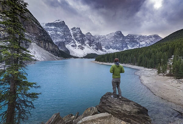 Tourist watching the scenery of the Moraine Lake, Banff National Park, UNESCO World Heritage Site
