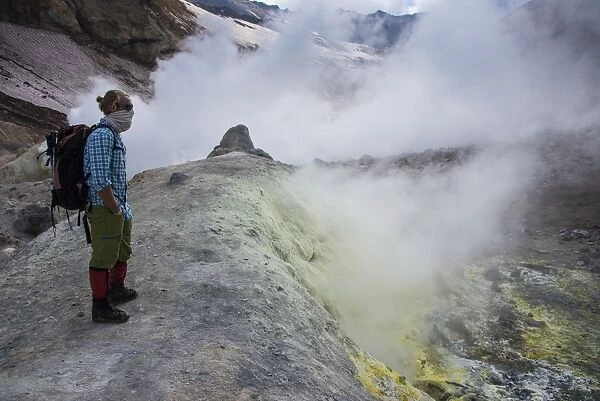 Tourists standing by smoking fumaroles on Mutnovsky volcano, Kamchatka, Russia, Eurasia