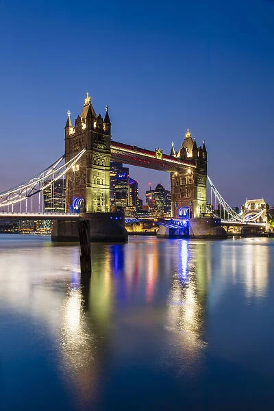 Tower Bridge and The City of London skyscrapers reflecting in River Thames at sunset, London, England, United Kingdom, Europe