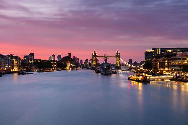 Tower Bridge, HMS Belfast, River Thames and Canary Wharf skyline at sunrise, London, England, United Kingdom, Europe
