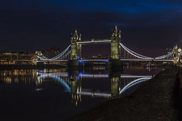 Tower Bridge at night just before sunrise, reflecting in a still River Thames, London, England, United Kingdom, Europe