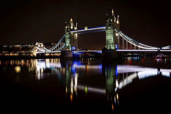 Tower Bridge and reflections in the River Thames at night, London, England