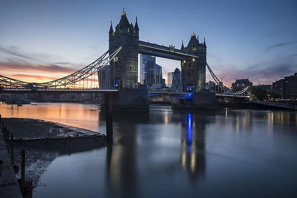 Tower Bridge at sunset reflected in the River Thames, London, England, United Kingdom